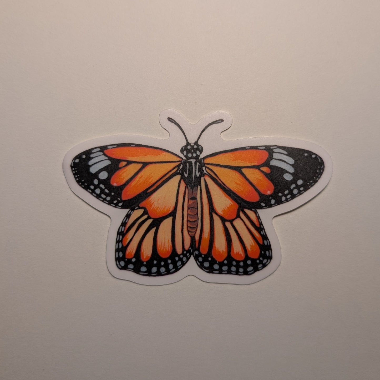 Picture of monarch butterfly sticker on white background.