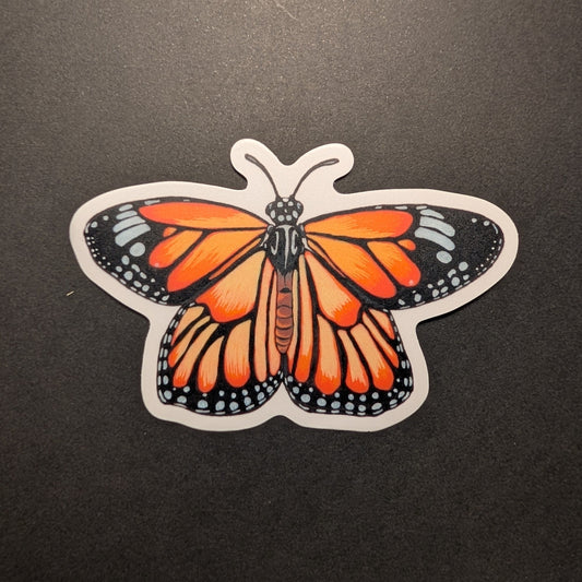 Picture of monarch butterfly sticker on black background.
