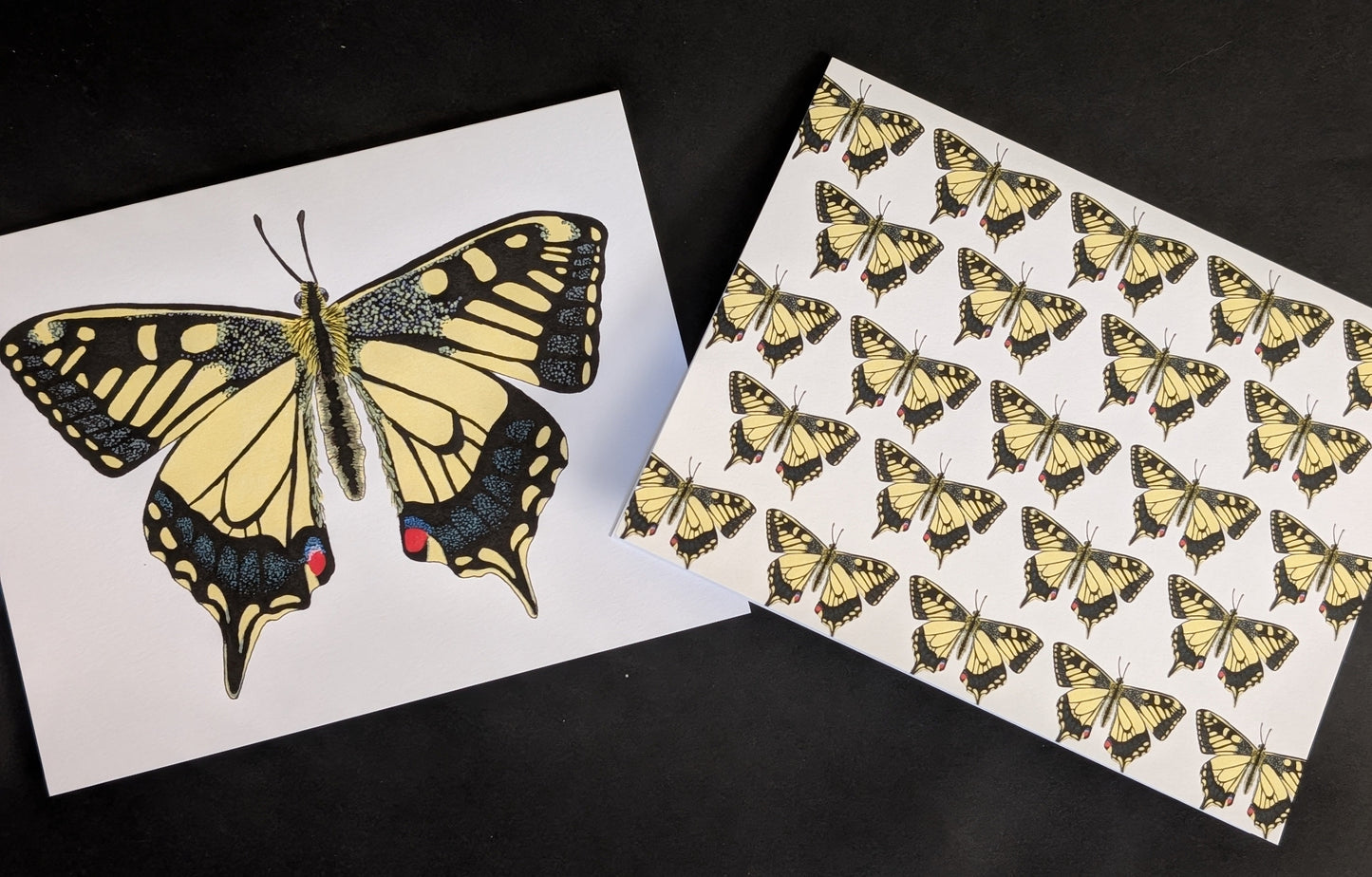 Two 4x6 cards on a black background. One card has a solo swallowtail butterfly on the front. The second card has a repeating pattern of swallowtail butterflies across the front.