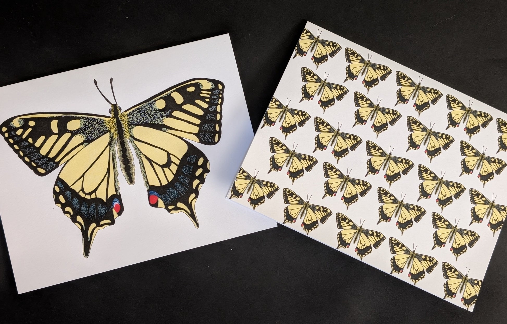 Two 4x6 cards on a black background. One card has a solo swallowtail butterfly on the front. The second card has a repeating pattern of swallowtail butterflies across the front.